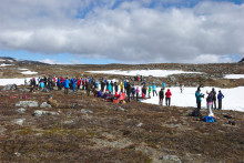 people watching ski race in front of snow field