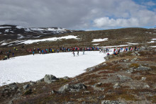 skiers racing over small snow field