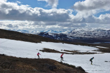skiers racing over small snow field